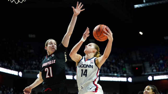 UConn forward Dorka Juhasz (14) shoots the ball against Louisville Cardinals forward Emily Engstler (21).